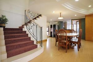 a dining room and kitchen with a staircase and a table and chairs at KK Vacation Apartments@Marina Court Resort Condominium in Kota Kinabalu