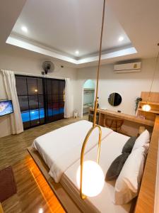 a bedroom with a large bed and a desk at Dara Homestay in Ko Kood