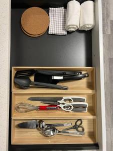 a drawer with scissors and other kitchen utensils at Walking distance to St Boniface, easy parking in Winnipeg