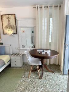 a bedroom with a desk and a bed and a table at Terra Nova in Mýkonos City