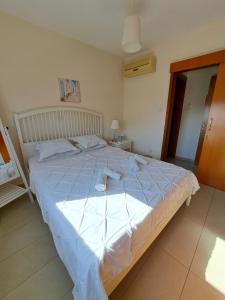a bedroom with a large bed with a blue comforter at Albert's apartment Centre 601 in Larnaca