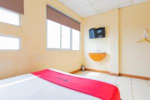 a room with a bed and a flat screen tv at RedDoorz @ Iodium Residence Cikarang in Jakarta