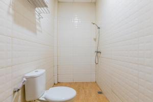 a bathroom with a toilet and a shower at RedDoorz @ Iodium Residence Cikarang in Jakarta +18 photos