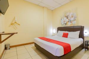 a bedroom with a large bed in a room at RedDoorz @ Iodium Residence Cikarang in Jakarta