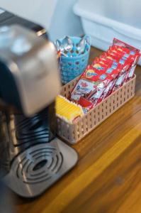 a toaster on a counter next to a basket of chips at U Villa Chiangkhan (อยู่วิลล่าเชียงคาน) in Chiang Khan