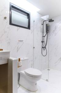 a bathroom with a toilet and a glass shower at U Villa Chiangkhan (อยู่วิลล่าเชียงคาน) in Chiang Khan