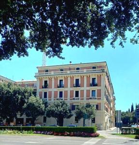 a large building with a tree in front of it at Luxury Verona Apartment City Centre in Verona