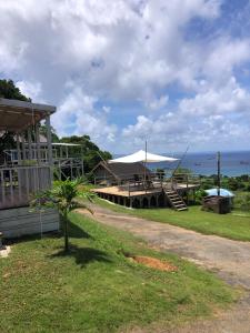 a house with a porch and a view of the ocean at PANORAMA Ocean View Cottage in Motobu