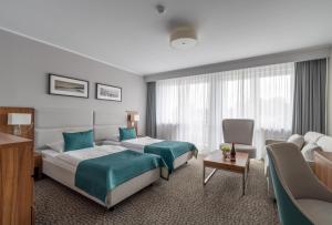 Postel nebo postele na pokoji v ubytování Hotel Wolin + 30 fotografií