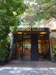a building with a sign for a not suites at Monot Suites in Beirut