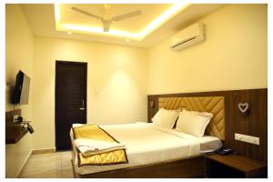 a bedroom with a bed with a ceiling fan at Starwin Residency in Rāmanāthapuram