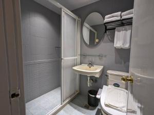 a bathroom with a shower and a toilet and a sink at 亞馨文旅 YesHome Hotel in Hualien City