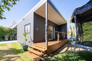 a house with a large deck on the side of it at Cozy 1 Bed 1 Bath Tiny Home near CBD in Brisbane