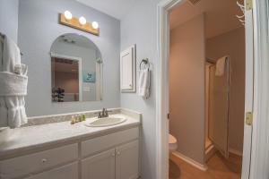 a bathroom with a sink and a mirror and a toilet at Guadalupe Retreat RR 1324 in New Braunfels +32 photos