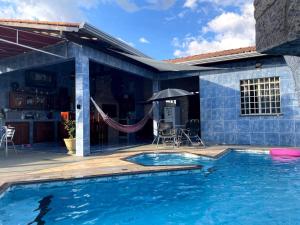 a house with a swimming pool and a patio at MiniRooms in Boa Vista