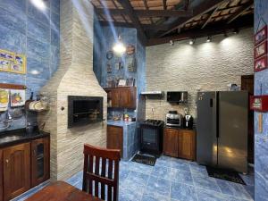 a kitchen with a stove and a refrigerator at MiniRooms in Boa Vista