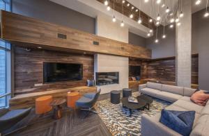 a living room with a couch and a tv at Milpitas 1BR w Pool Gym WD nr BART SFO-747 in Milpitas