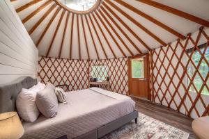 a bedroom with a bed in a yurt at OT 3515A Texas Yurt Haus Armadillo in New Braunfels