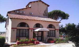 a small building with flowers in front of it at Agriturismo Il Poderino in Tarquinia