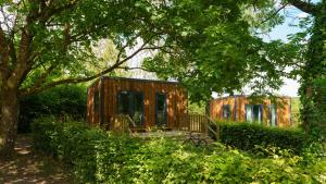 a cabin in the middle of a forest with trees at Camping Vittel in Vittel