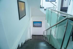 a staircase in a building with glass railing at Florence Villas in Jaffna +89 photos