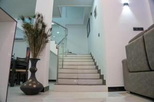 a staircase with a vase next to a stair case at Florence Villas in Jaffna