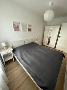 sypialnia z łóżkiem z czarnym kocem w obiekcie Apartament 34 Sun Towers w Świnoujściu +12 zdjęć
