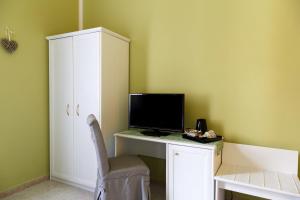 a room with a desk with a monitor and a chair at Leone X Guest House in Florence