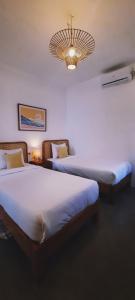 Cama o camas de una habitación en Betah Homestay Banyuwangi