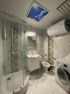 a bathroom with a shower and a toilet and a sink at Bluemoon-Apartment with Parking in Burgas