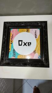 a picture in a black frame with the word ike at Casa Frida 3 in Natal