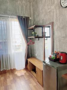 a kitchen with a counter and a window and a table at Amy Hostel Hue in Hue