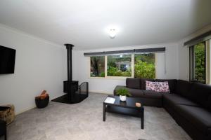 a living room with a couch and a fireplace at Rose Cottage Nannup in Nannup