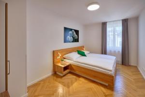 a bedroom with a bed and a window at DownTown Suites Rubesova in Prague