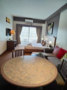 a hotel room with a table and a bed at Seaview Deluxe@Rainbow Paradise Tg Bungah 4pax in Tanjung Bungah