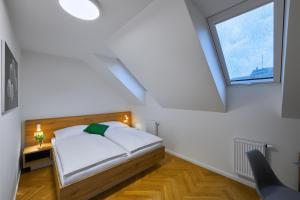 a bedroom with a bed and a window at DownTown Suites Rubesova in Prague