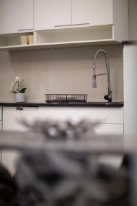 a kitchen counter with a sink and a faucet at Deluxe Izabella Apartment in the Center of Budapest in Budapest