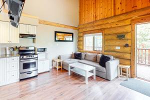 a living room with a couch and a stove at Lac Le Jeune at Cabin 29 and 30 in Kamloops