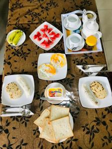 a table topped with plates of eggs and toast at Dambulla Tourist Resort in Dambulla