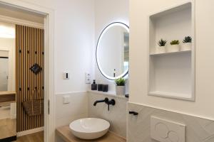 a bathroom with a toilet and a mirror at Villa Chloe Binz Appartements exklusiv in Top Lage in Binz +104 photos