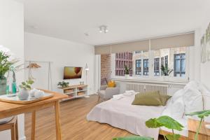 sala de estar con cama, mesa y sofá en MEL&BENS Domshof Zentrum Balkon, en Bremen