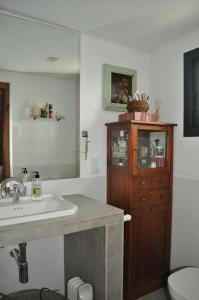 a bathroom with a sink and a wooden cabinet at Casa rural La Liñana in Córdoba