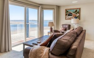 a living room with a couch and a table at Dock of The Bay #203 in Lincoln City