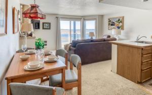 a living room with a table and a kitchen with a couch at Dock of The Bay #203 in Lincoln City