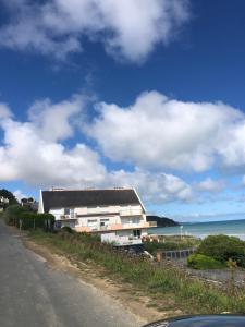 ein Gebäude an der Seite einer Straße neben dem Meer in der Unterkunft T2 Vue MER COSY HORIZON PLAGE in Plérin