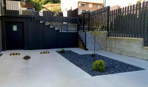 a parking lot with a gate and a stair case at TEILOR Apartments 5 in Floreşti