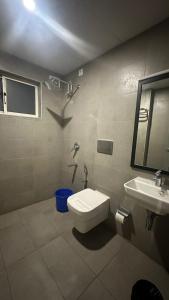 a bathroom with a toilet and a sink at Hotel B R REGENCY in Trivandrum