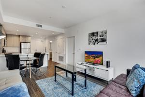 a living room with a couch and a table at Apart Hotel at Chinatown in Los Angeles