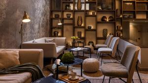 a waiting room with couches and tables and shelves at Mobile Homes Terme Jezercica in Donja Stubica