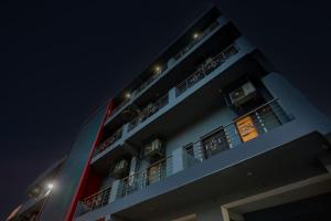 a tall building with balconies at night at OYO Townhouse 589 Hotel Diamond View in Greater Noida